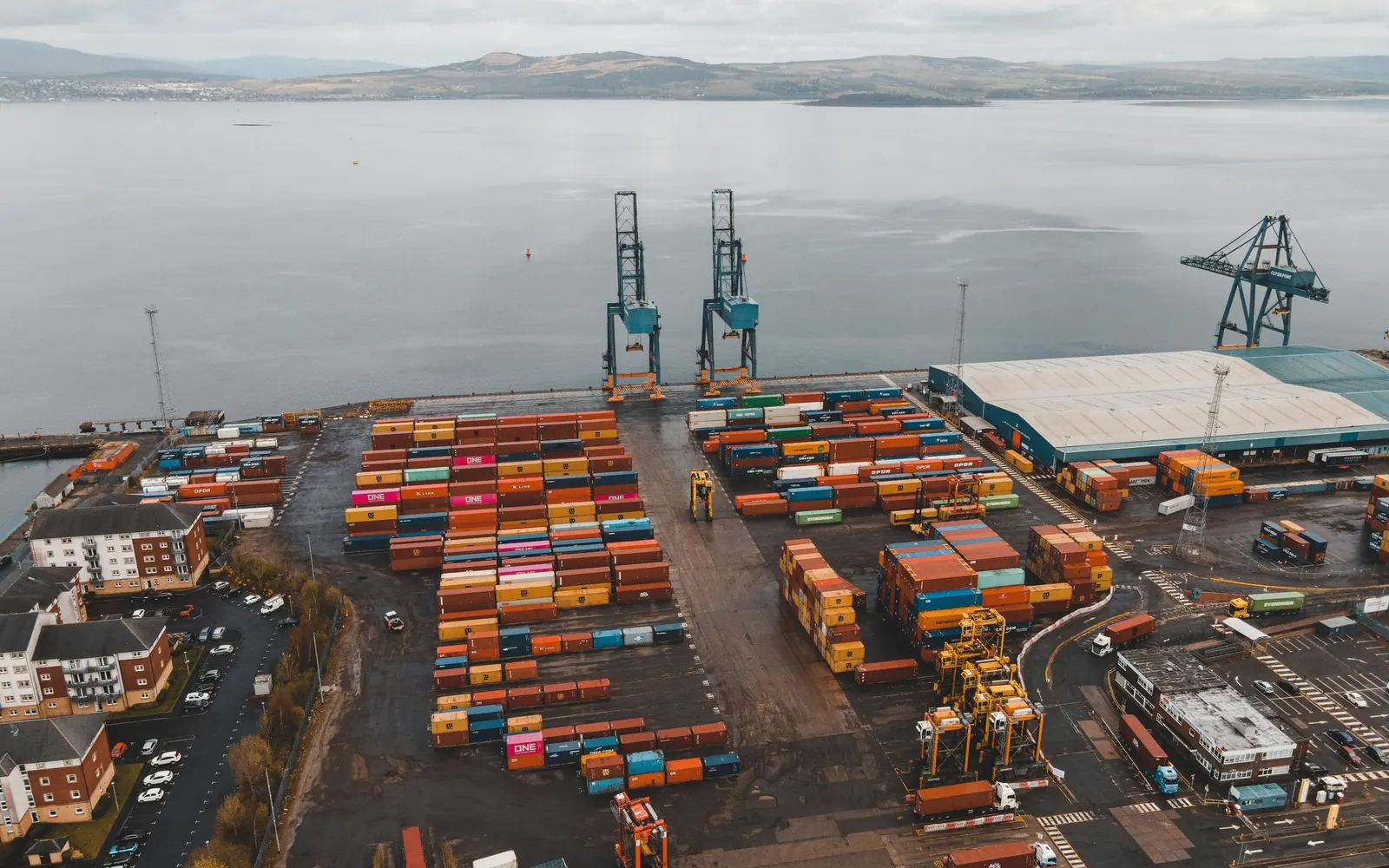 Container terminal and cranes beside coastal waters